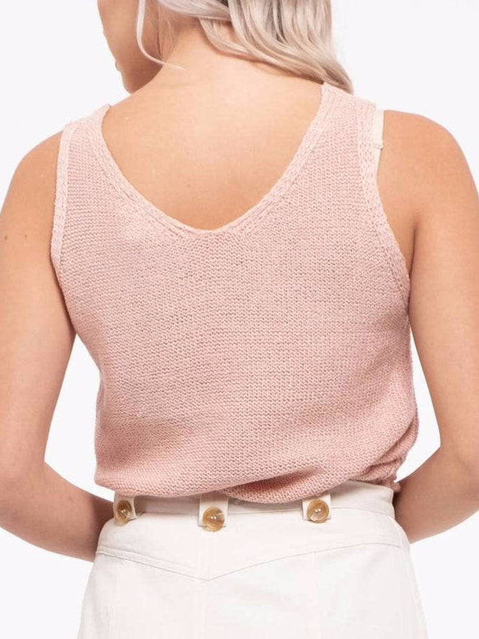 Back view of a blush pink knit tank top with a V-neck, shown on a model.