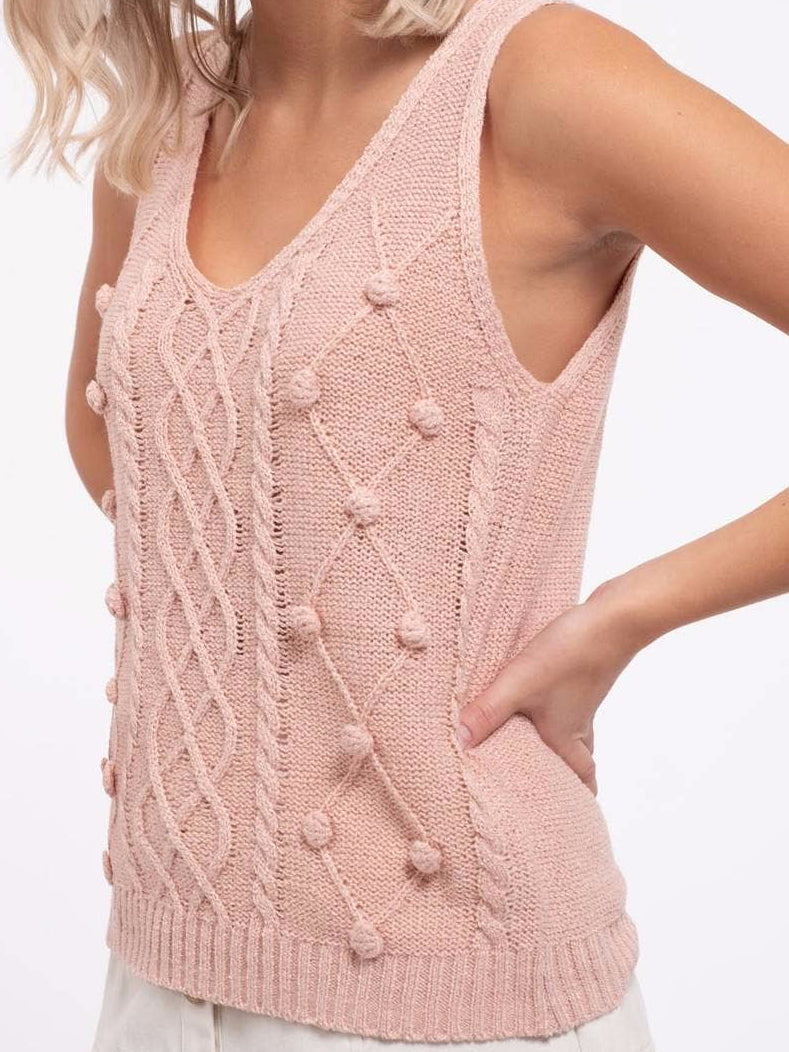 Pink cable knit Sweet Beauty tank top with delicate pom-poms.