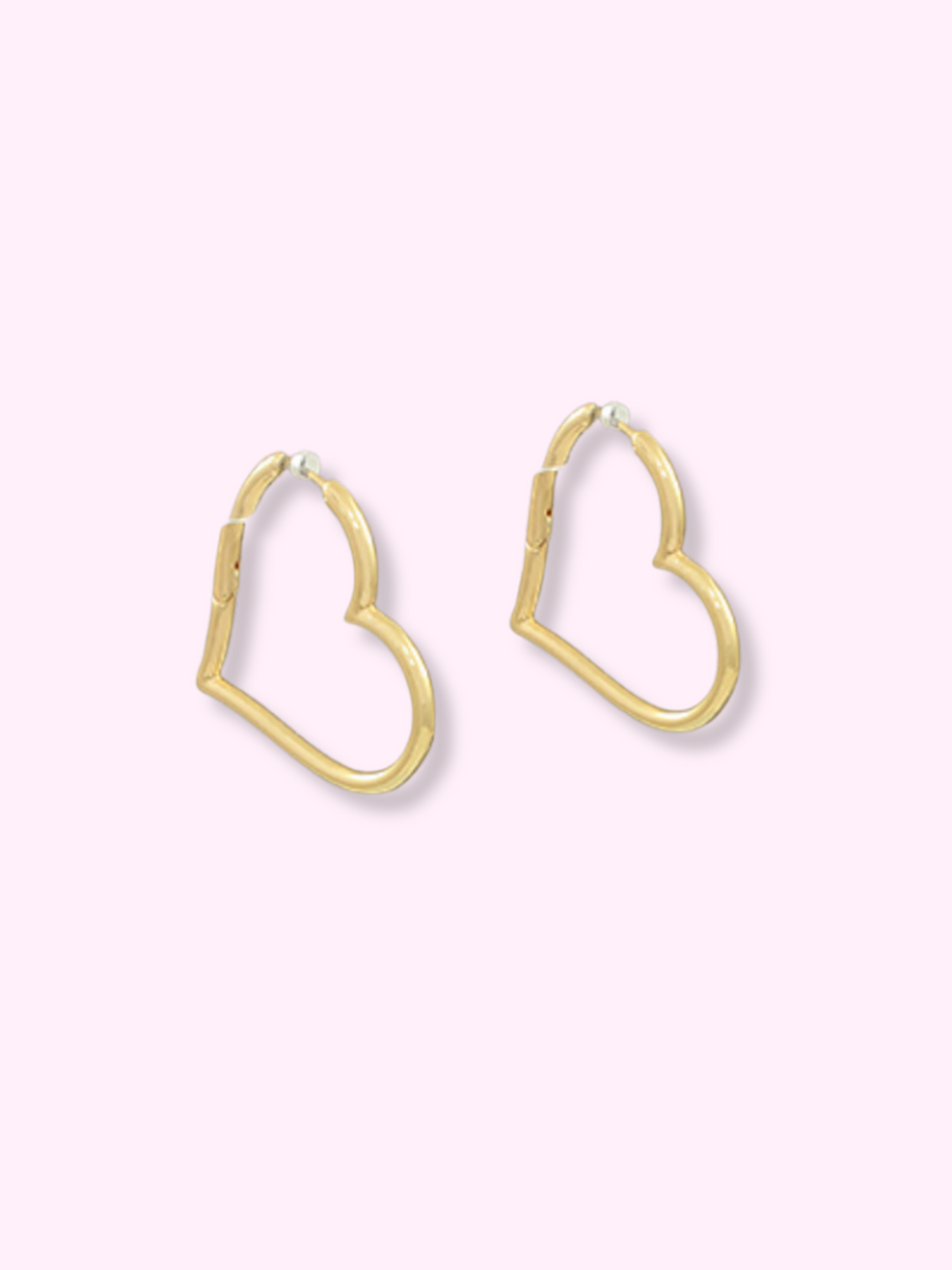 Gold heart-shaped hoop earrings.
