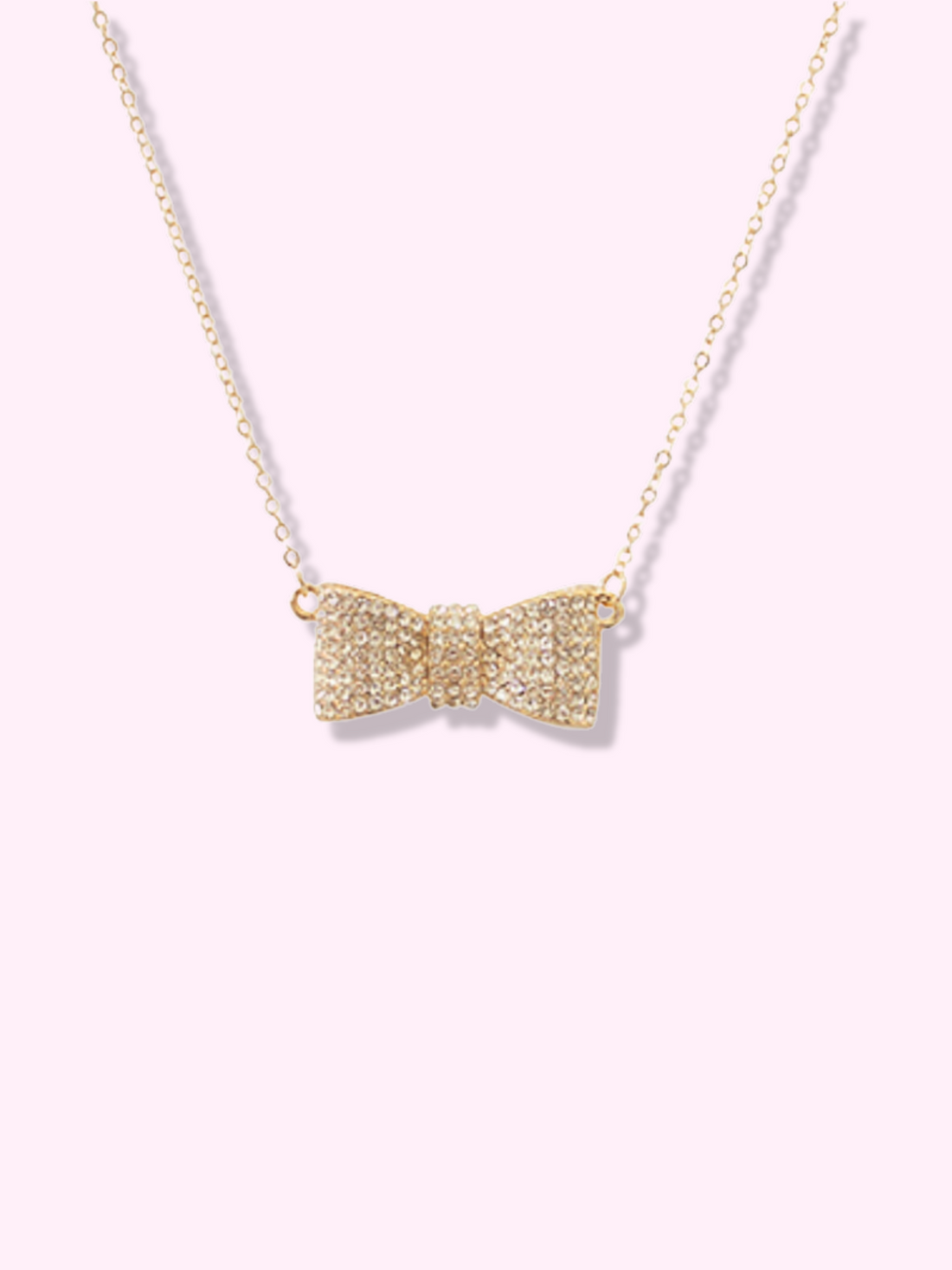 Gold rhinestone bow necklace with delicate chain.
