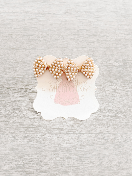 Pearl bow earrings with gold accents
