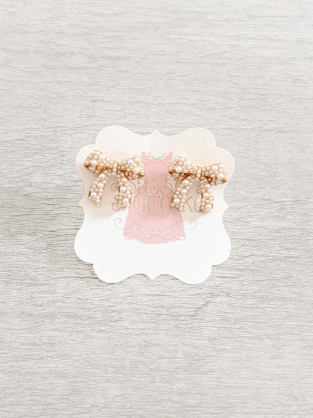 Sadie Bow pearl earrings: gold tone bow adorned with creamy white pearls.
