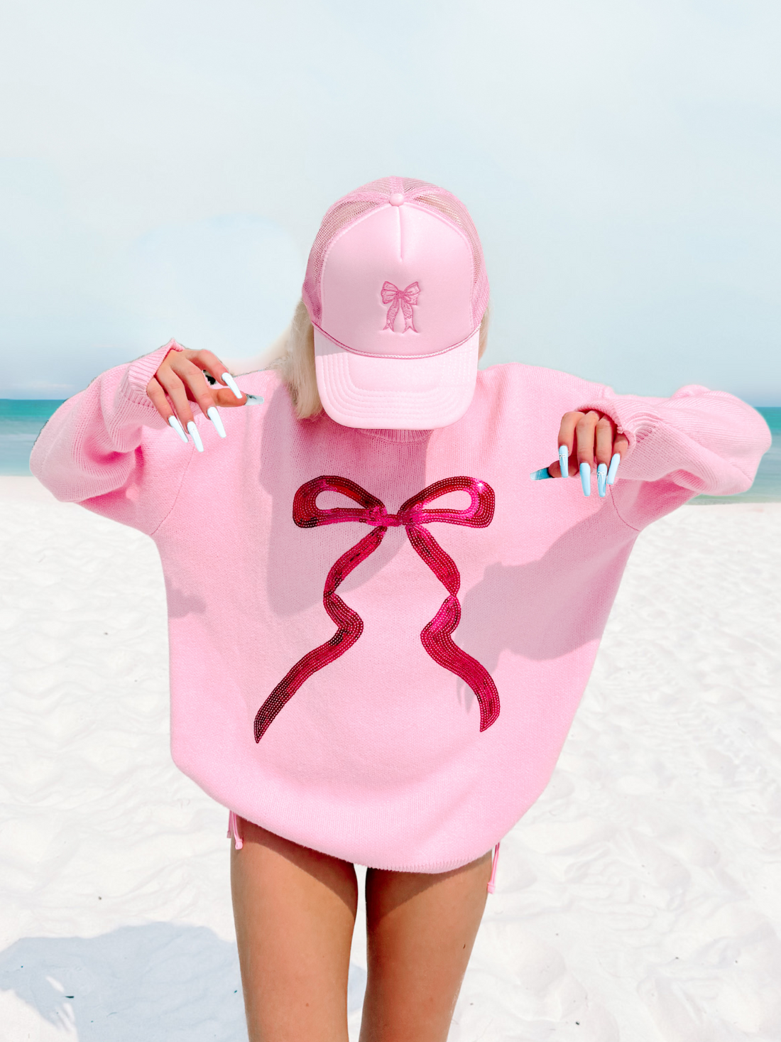 Pink bow hat with embroidered bow detail.
