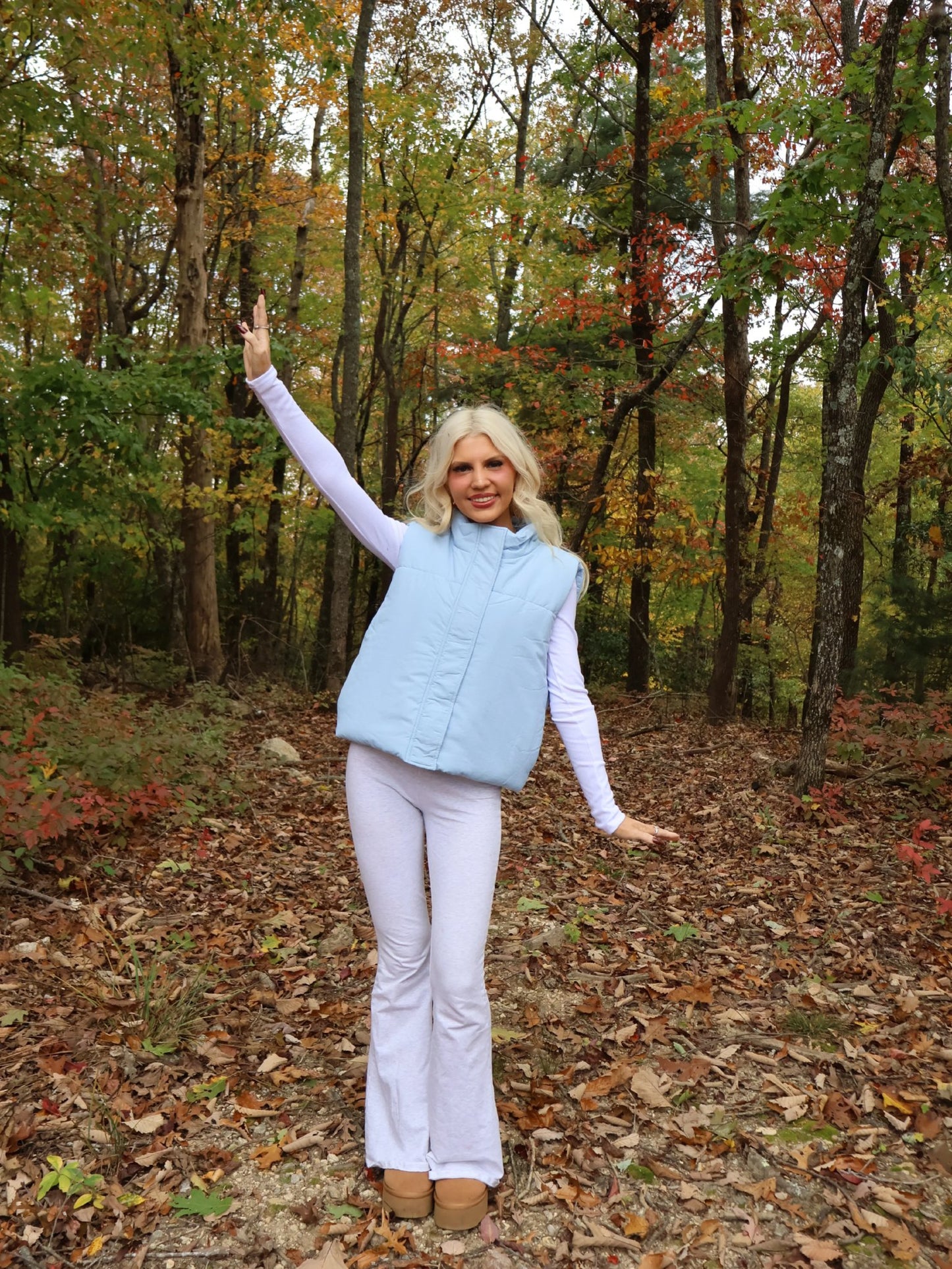 Alpine Air Vest - Sassy Shortcake - full body outdoor view of light blue vest with arms raised