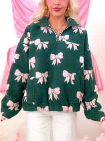 Sassy Shortcake Bundled in Bows Pullover, a hunter green sherpa jacket with pink bow details and a convenient quarter zip closure.