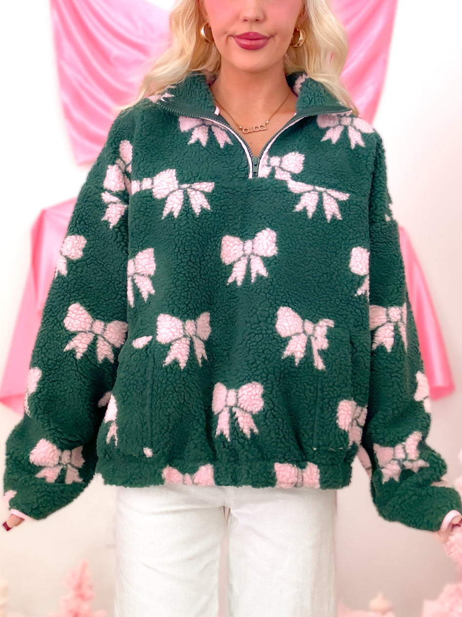 Sassy Shortcake Bundled in Bows Pullover, a hunter green sherpa jacket with pink bow details and a convenient quarter zip closure.