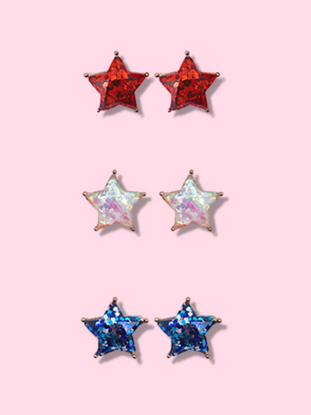 Sparkly star-shaped earrings in red, iridescent, and blue glitter.
