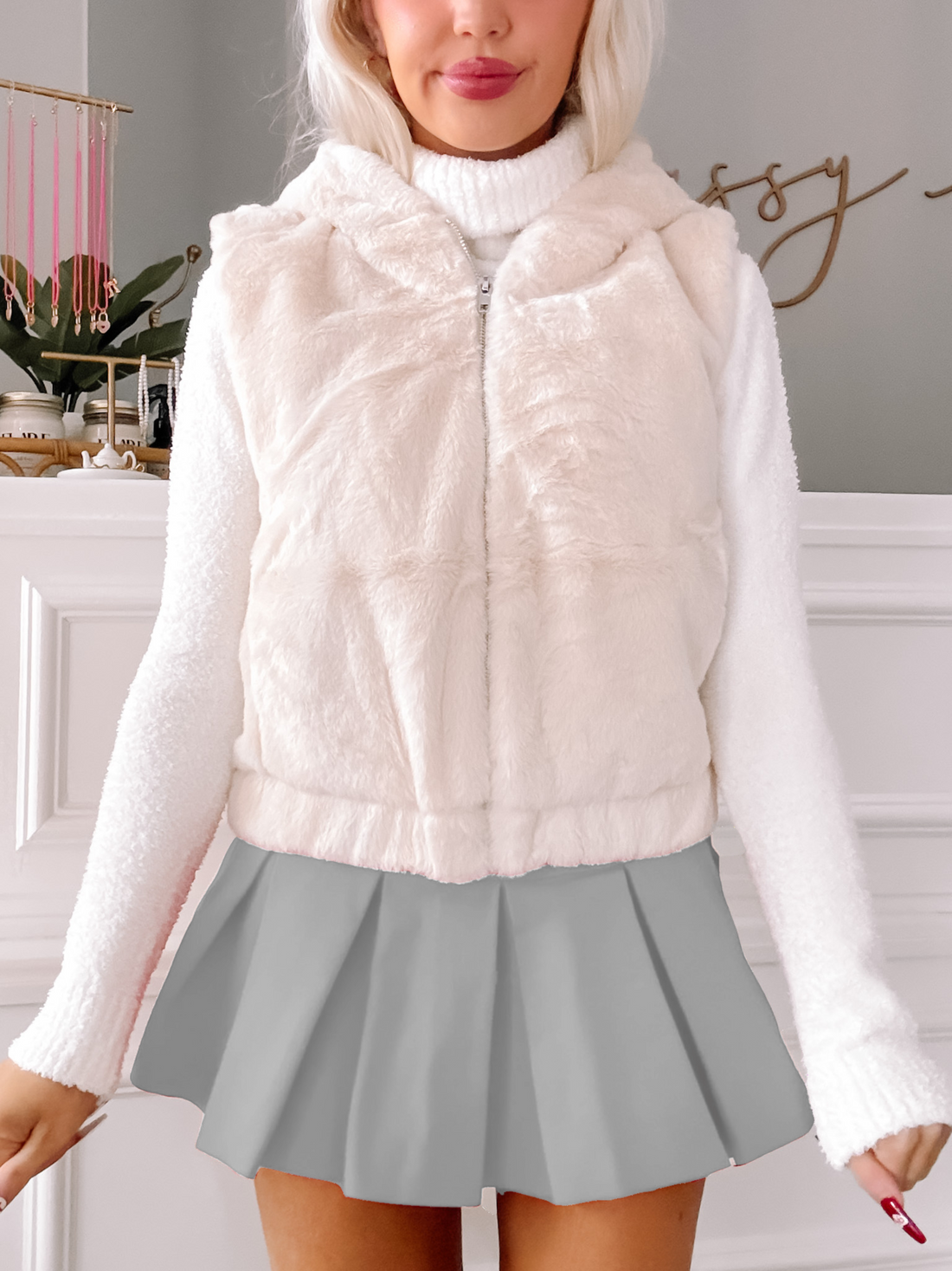 Ivory Winter Warmth faux fur vest with zipper closure.
