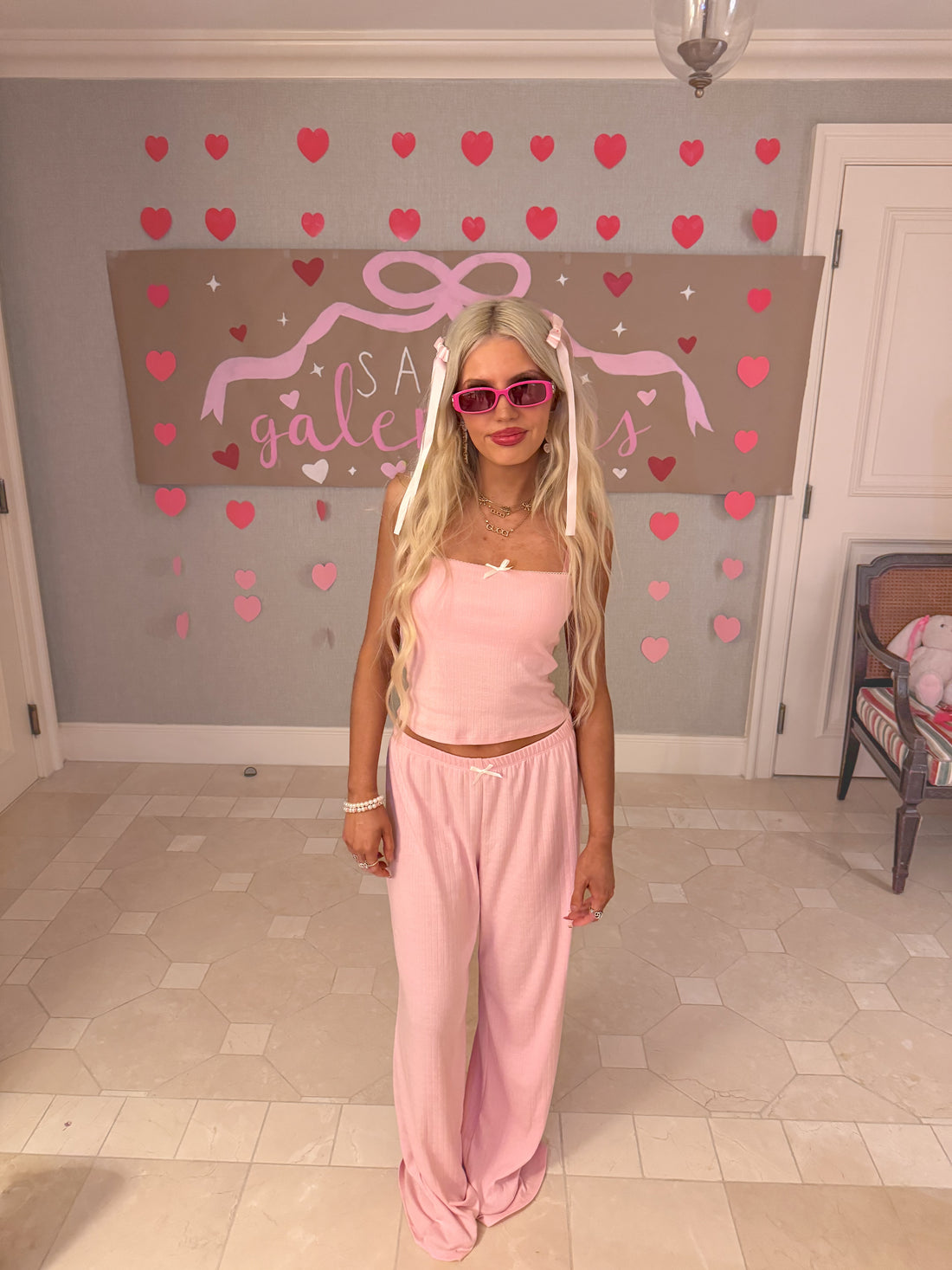 Pink pajama set styled against a Valentine's Day backdrop.
