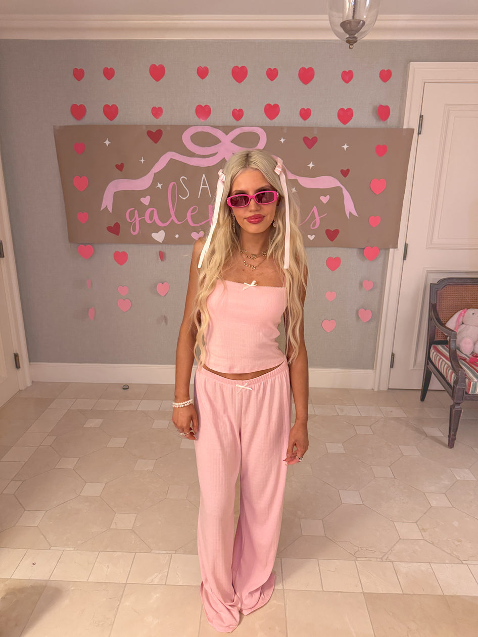 Pink pajama set styled against a Valentine's Day backdrop.

