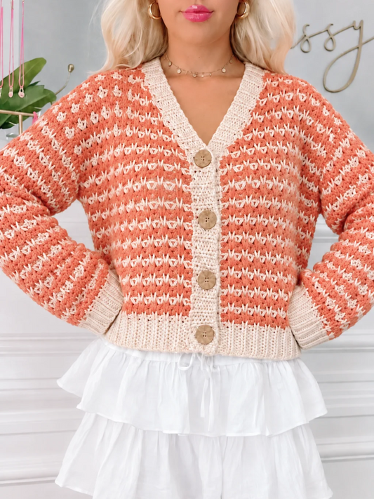 Harvest Hayride chunky knit cardigan in rust and cream with a V-neck and wood buttons, styled with a white ruffle skirt from Sassy Shortcake