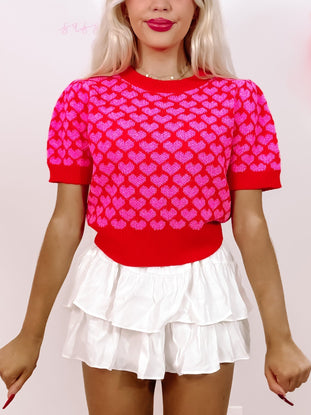 Red heart-print cropped sweater; Valentine's Day top.
