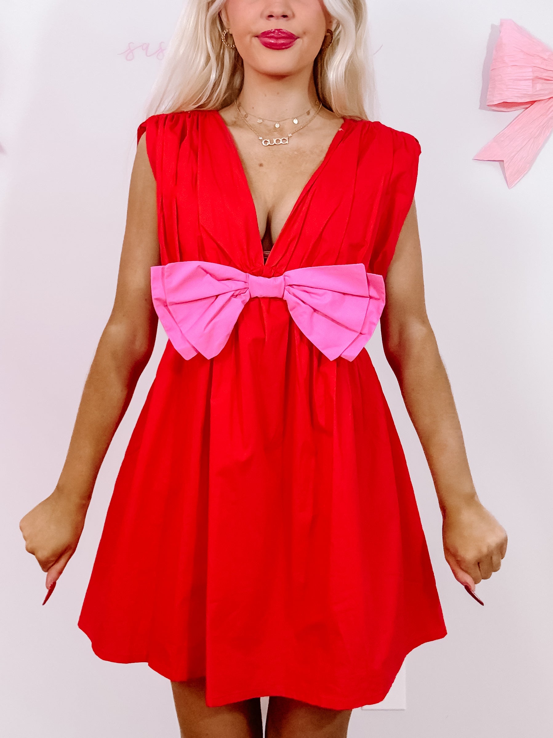 Red Bow Me Away dress with a pink bow detail.
