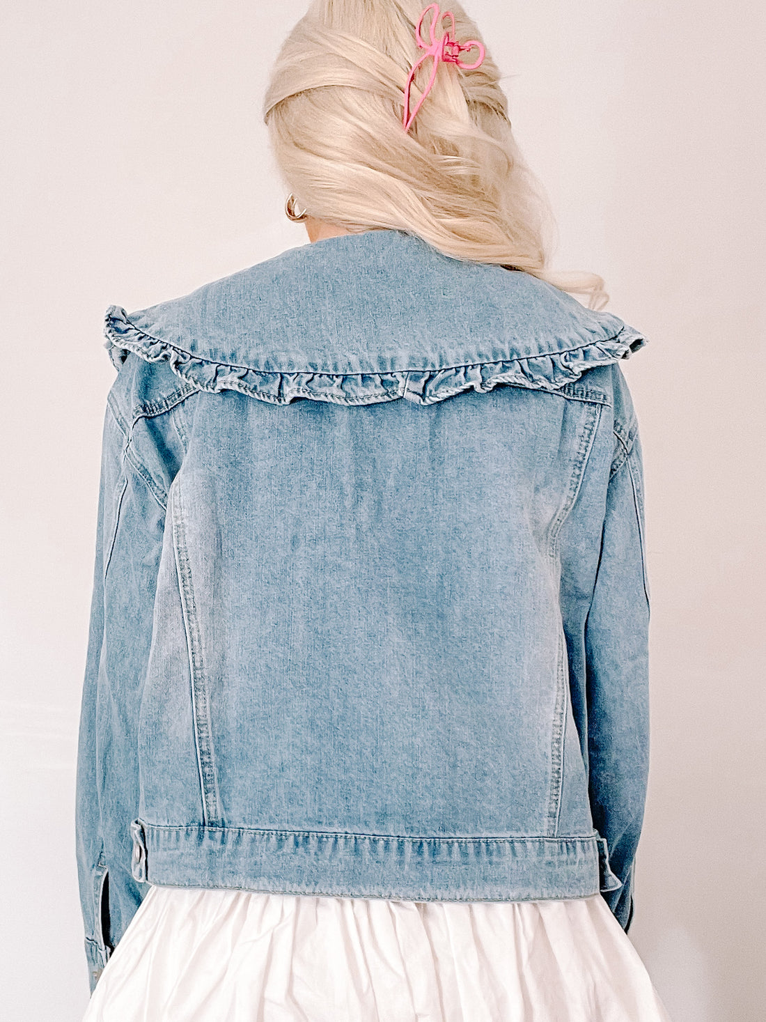 Light wash denim jacket with ruffled collar, shown from the back. Denim Doll Jacket from Sassy Shortcake 
