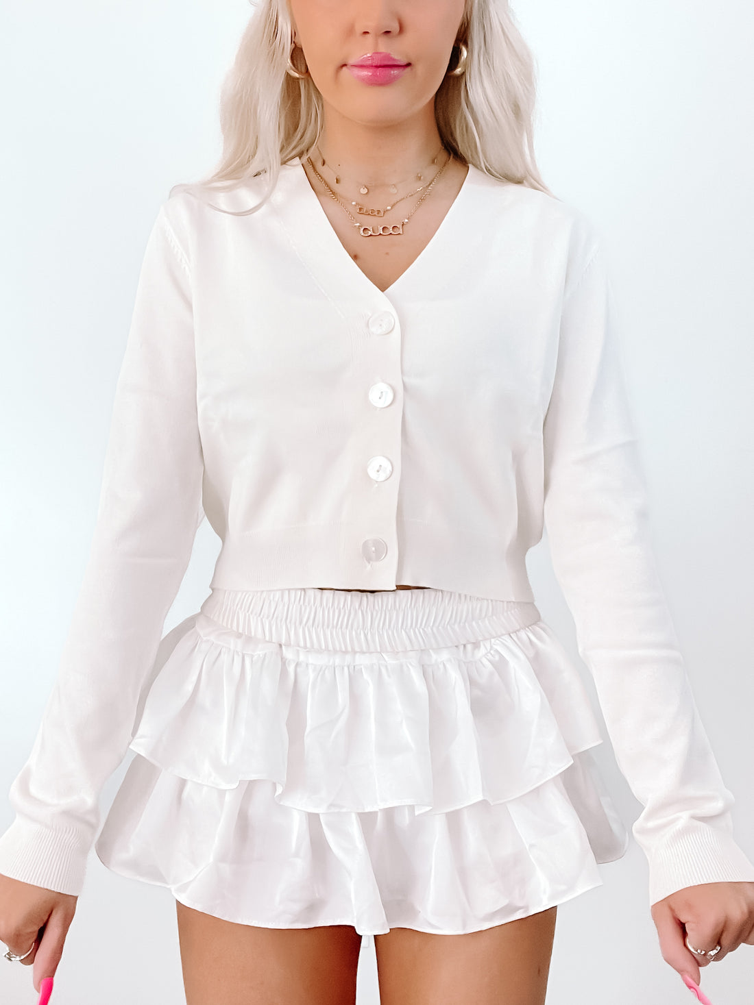 Ivory Spencer Cardigan:  Cropped, button-front knit cardigan in white.
