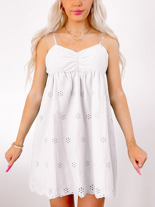 Lemonade Breeze eyelet mini dress in white, featuring a fitted bodice and flowy skirt.
