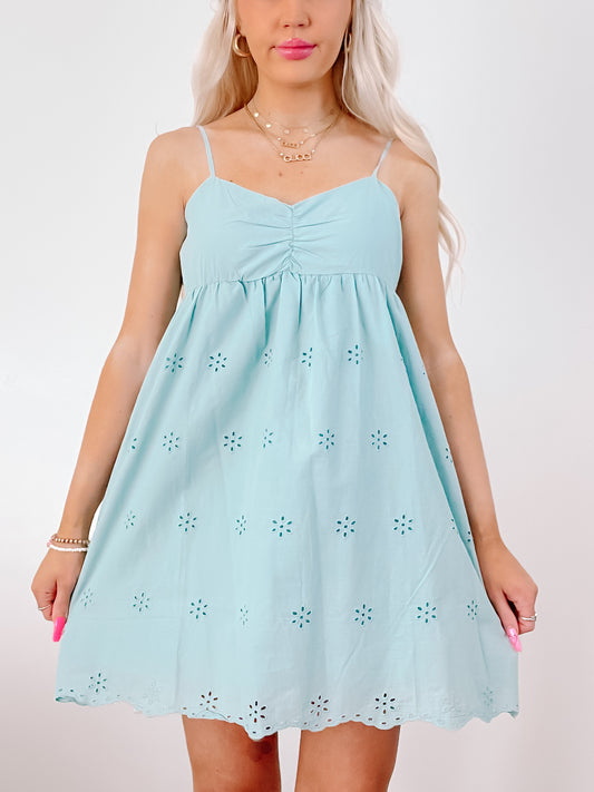 Eyelet-embellished teal blue sundress, summer fashion.
