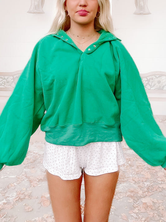 Green Brynn pullover top with balloon sleeves and button placket.
