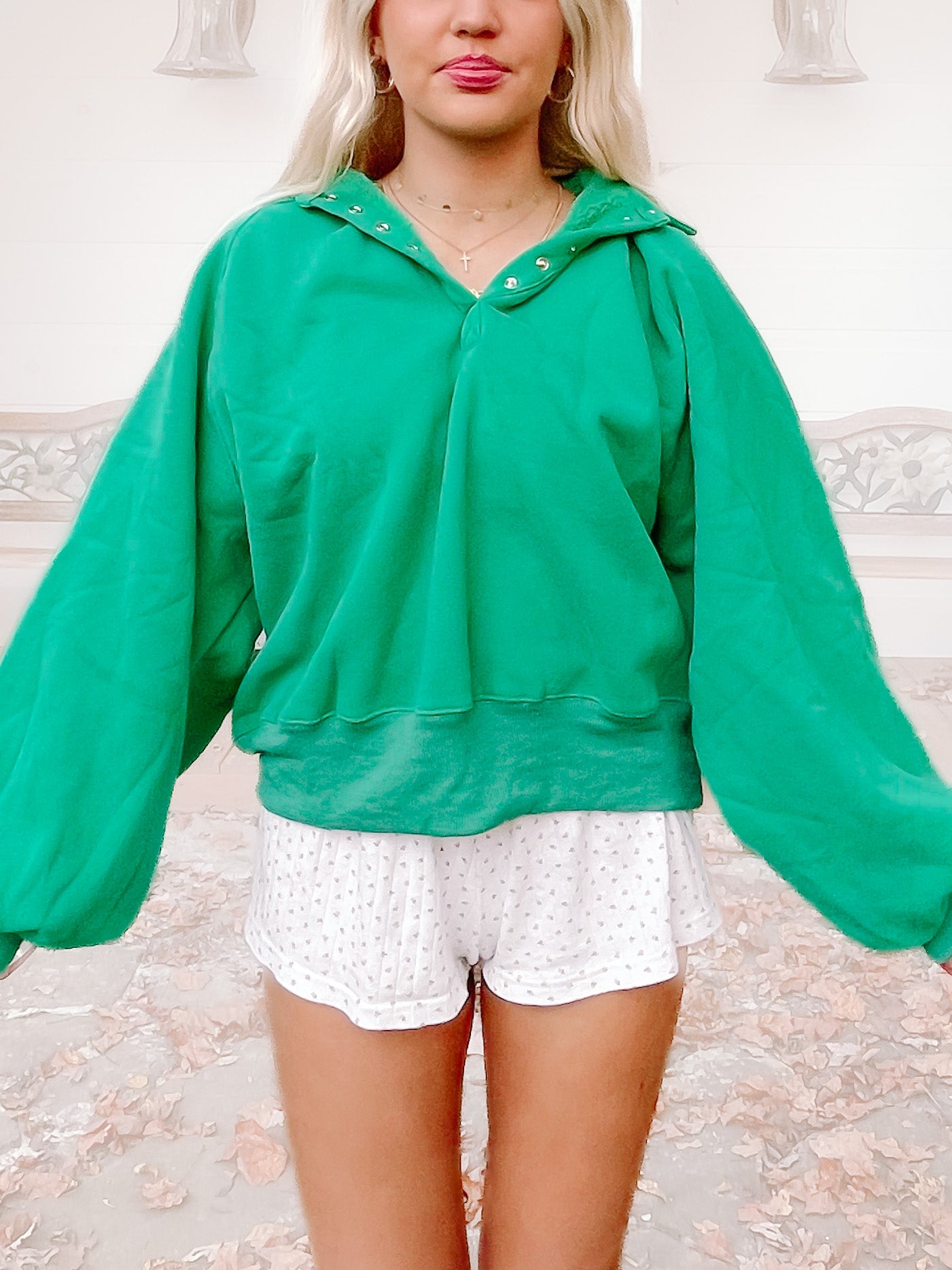 Bright green pullover sweater with balloon sleeves, shown on model.
