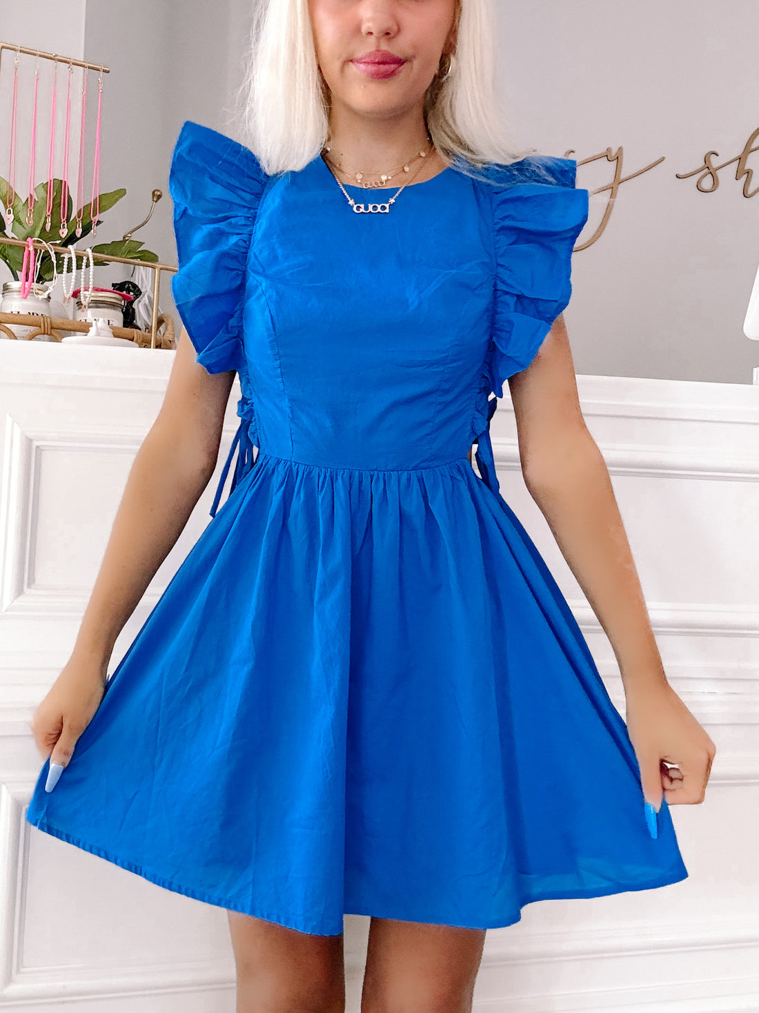 Royal blue mini dress with ruffled sleeves and a cinched waist.
