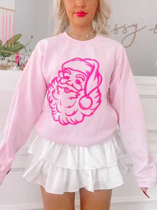 Pink crewneck sweatshirt featuring a hot pink neon Santa graphic from Sassy Shortcake; pink crewneck with hot pink Santa graphic