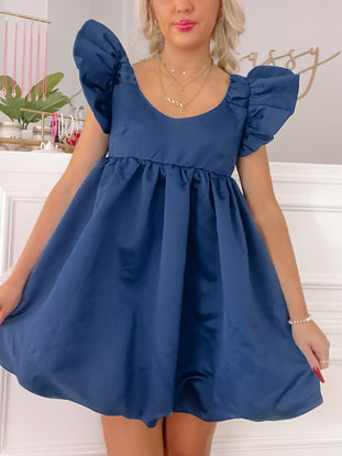 Navy blue fit-and-flare mini dress with puffed sleeves, shown on a model.
