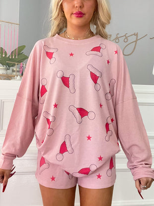 Pink waffle-knit Christmas pajama set featuring Santa hats and stars.
