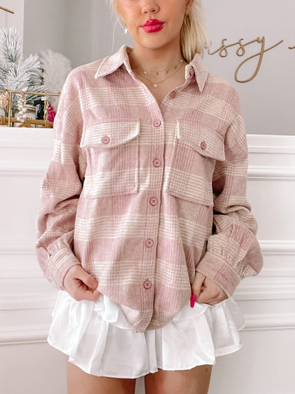 Pink and white plaid shacket styled with a white ruffled skirt.
