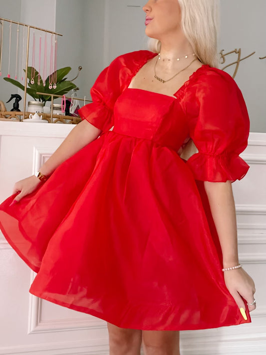 Red organza mini dress with puff sleeves and square neckline.