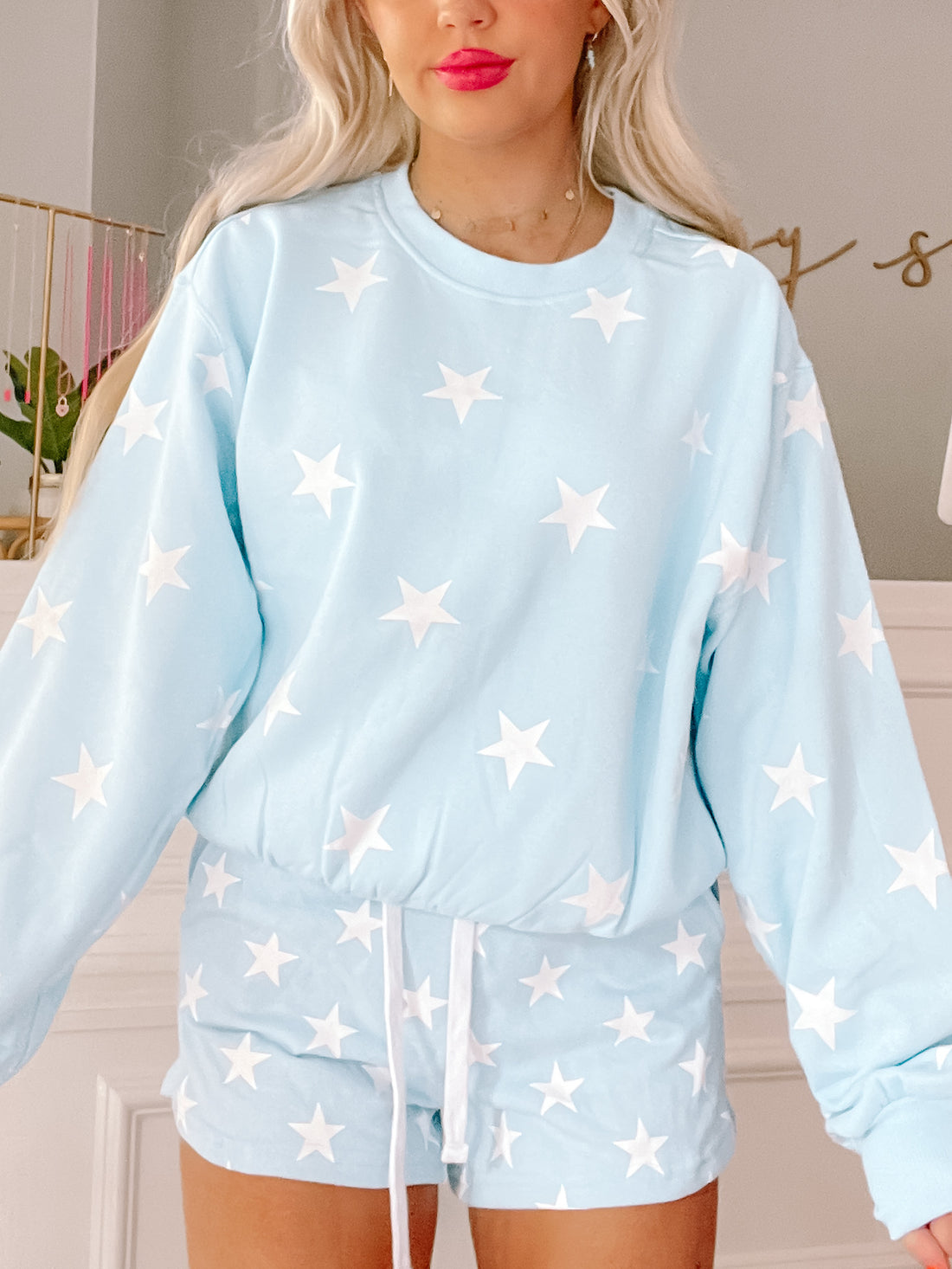 Light blue shorts with a white star pattern, shown with matching top.
