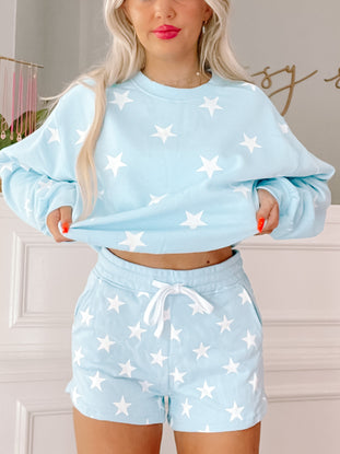 Light blue star print shorts; comfy, casual style.
