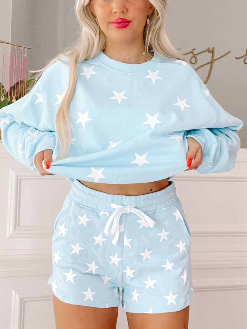 Light blue star print shorts; comfy, casual style.
