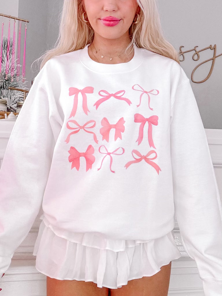 On Bow Nine Crewneck sweatshirt; white, features pink bow print, ruffled hem
