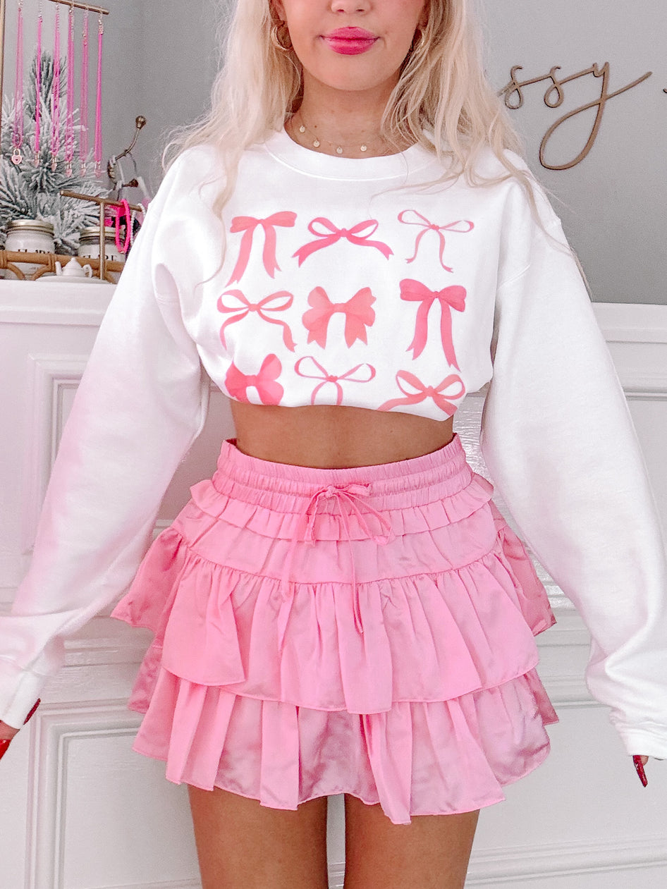 Baby pink Flirtatious Skirt: tiered, ruffle mini skirt.
