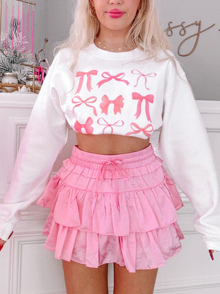 Pink ruffle mini skirt; flirty, layered design.
