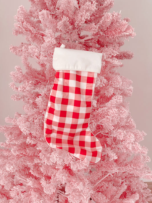 Red and white gingham Christmas stocking hanging on a pink flocked artificial tree at sassy shortcake