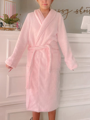 Pink fuzzy robe, soft and cozy for ultimate relaxation.
