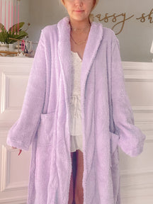 Lavender plush robe, long sleeves, and patch pockets.
