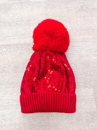 Red sequin beanie with faux fur pompom
