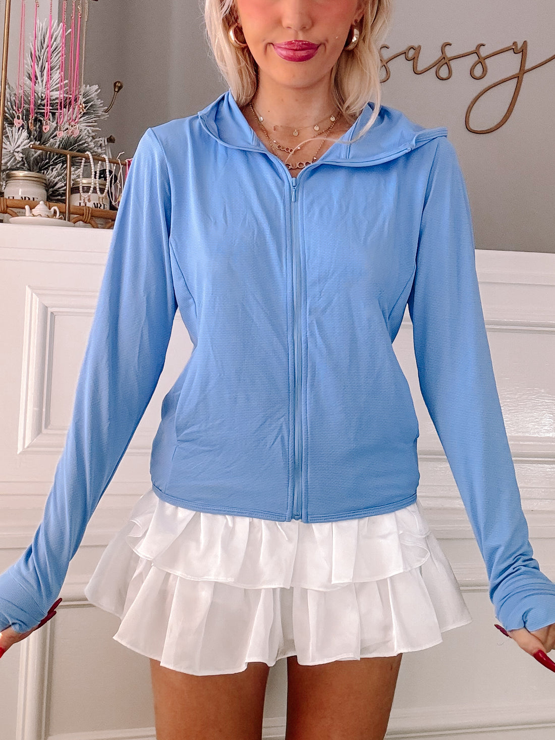 Light blue zip-up jacket with long sleeves and thumbholes.
