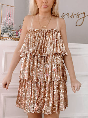 Rose gold tiered sequined mini dress, perfect for parties.
