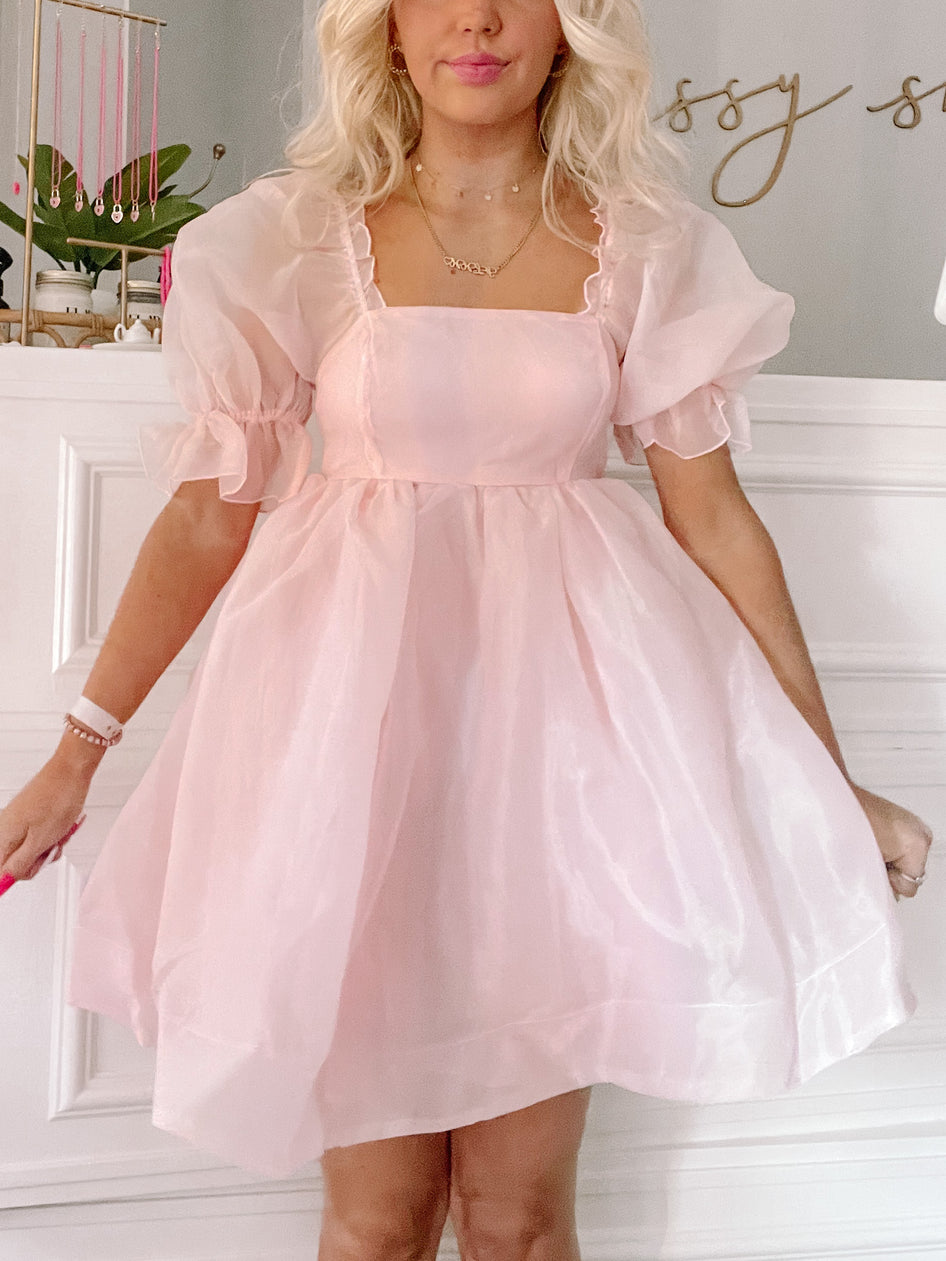 Blush pink mini dress with puff sleeves, square neckline; shown on model.
