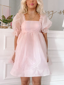 Blush pink Fruit Punch dress with puff sleeves and a square neckline.
