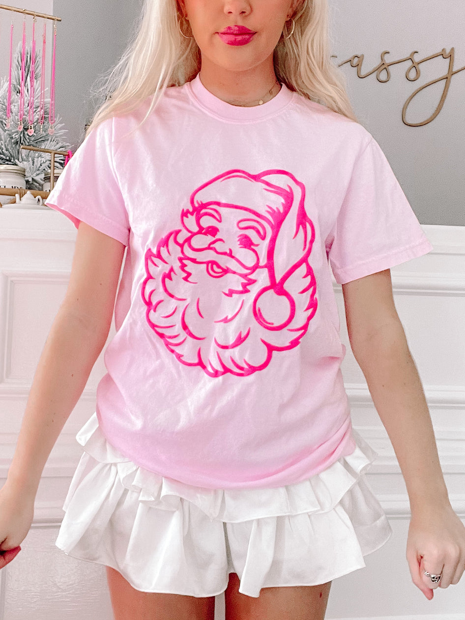 Neon pink Santa tee featuring a retro Santa graphic.
