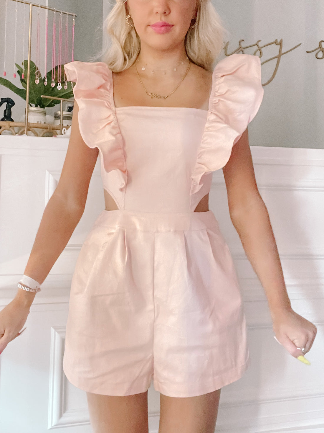 Pink "Make Me Blush" romper with ruffle sleeves and cutout detail.
