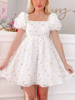 Starlight Dress: White mini dress with gold and silver stars, puff sleeves, and a square neckline.
