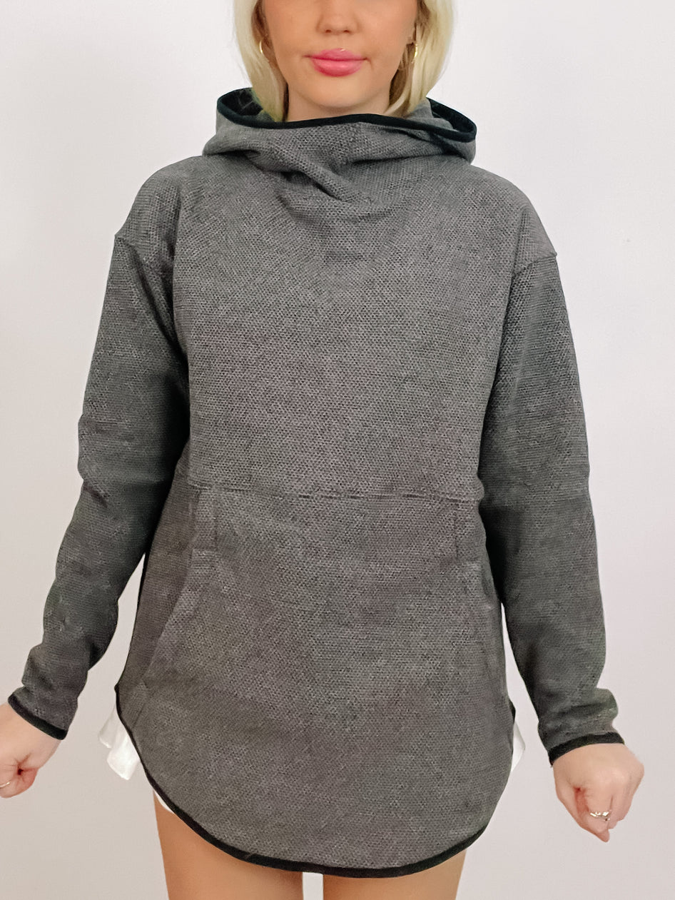 Gray textured long-sleeve hoodie with kangaroo pocket and curved hem.
