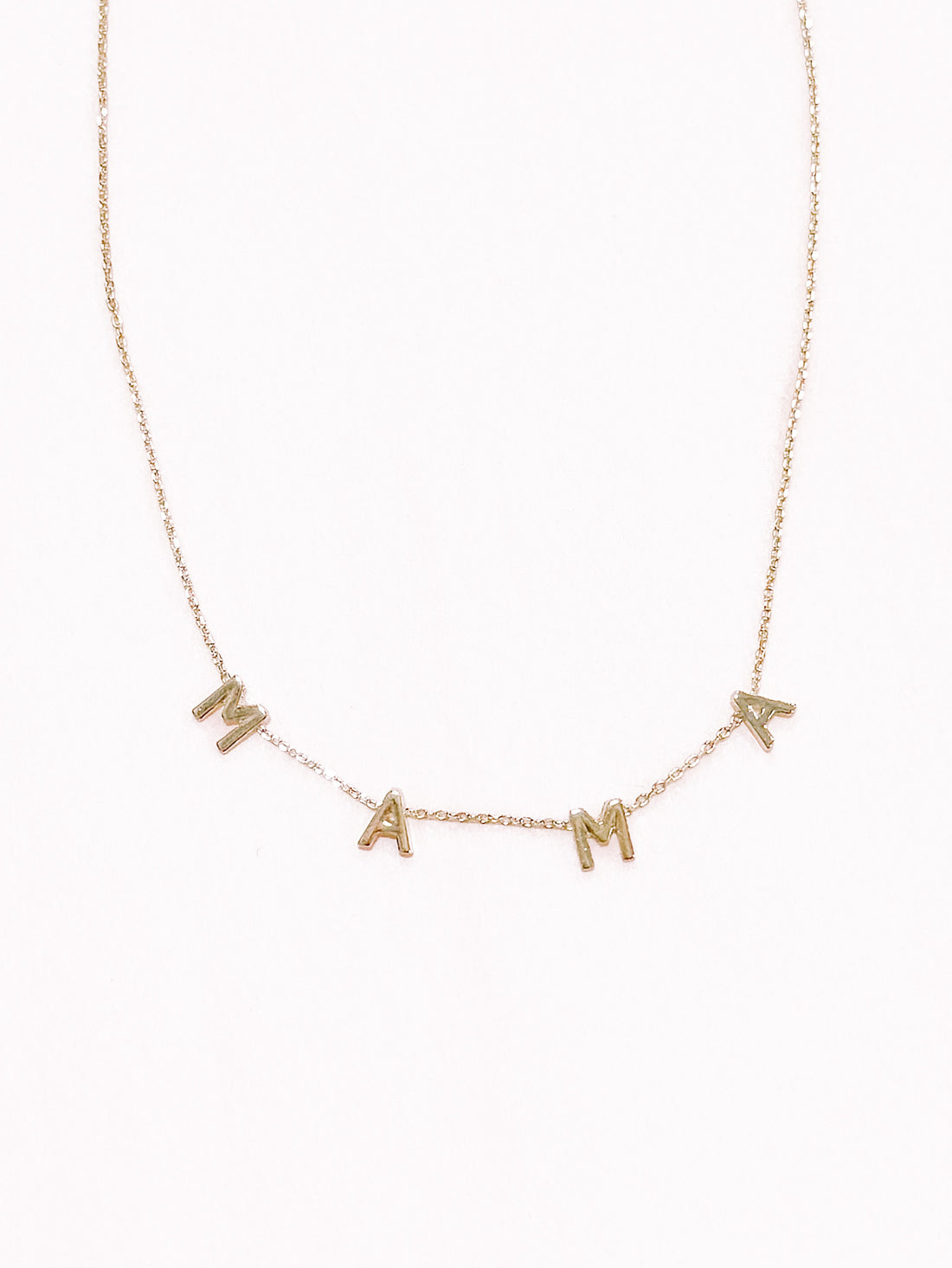 Gold Mama necklace with letter charms.
