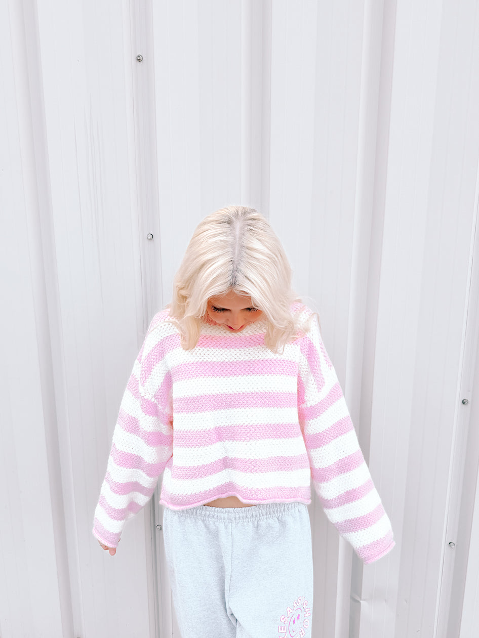 Pink and white striped knit sweater, casual style.
