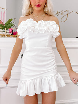 White off-the-shoulder ruffle mini dress, perfect for summer events.
